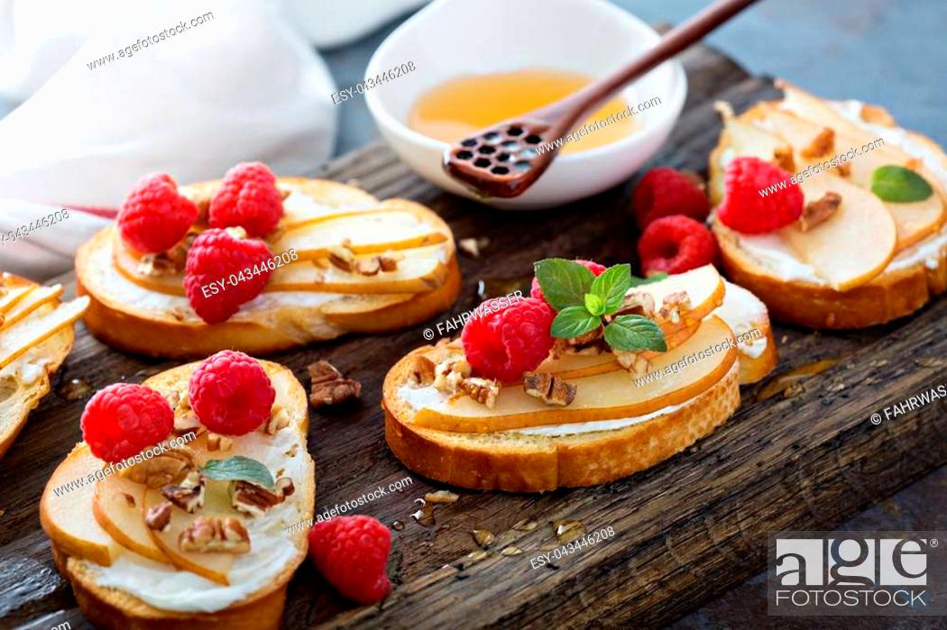 Stock Photo: Pear bruschetta with cream cheese, nuts and honey.