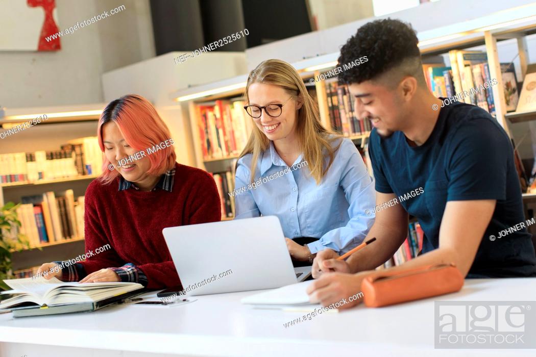 Stock Photo: Young people studying in library.