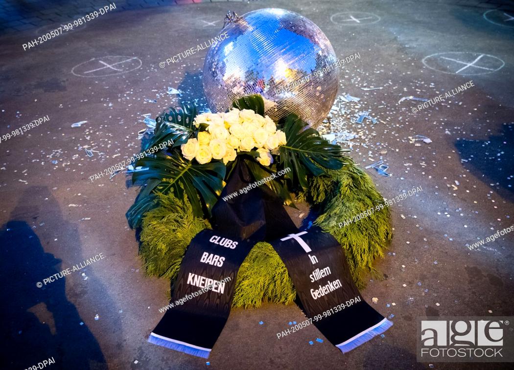 Stock Photo: 07 May 2020, Hamburg: A funeral wreath lies next to a burst disco ball at a protest action of neighbourhood restaurateurs.