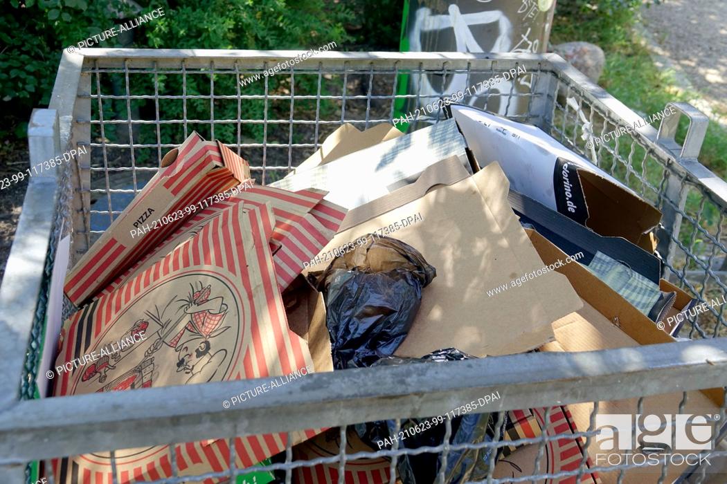 Stock Photo: 14 June 2021, Berlin: Empty pizza boxes lie in a public trash can in a park in Berlin-Friedrichshain. Photo: Alexandra Schuler/dpa.