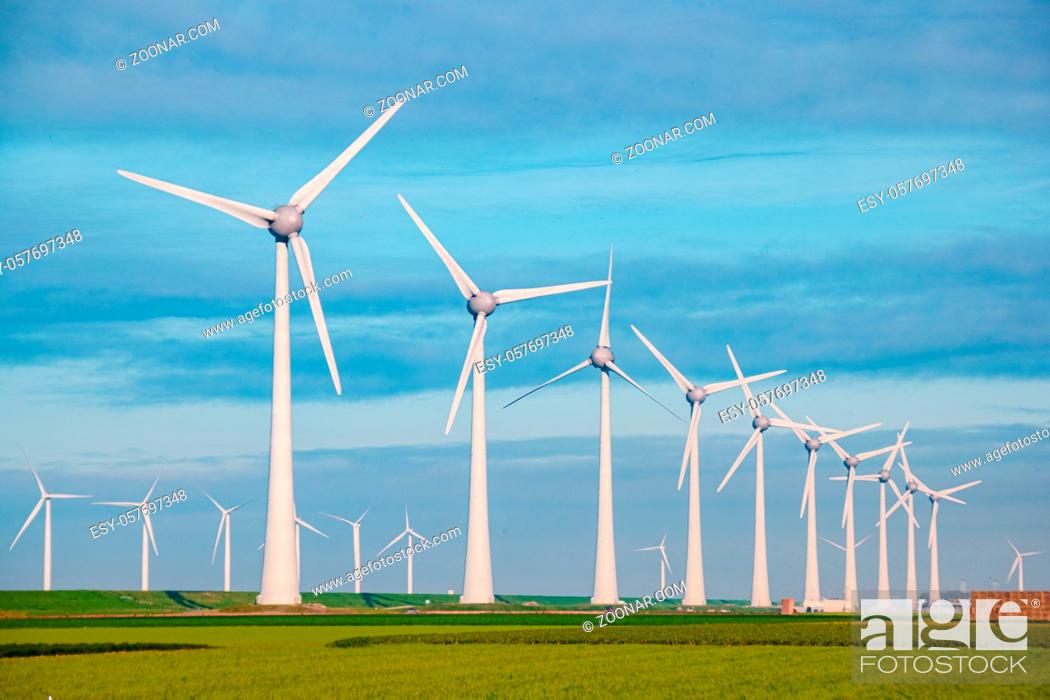 Stock Photo: Windmills for electric power production Netherlands Flevoland, Wind turbines farm in sea, windmill farm producing green energy. Netherlands.