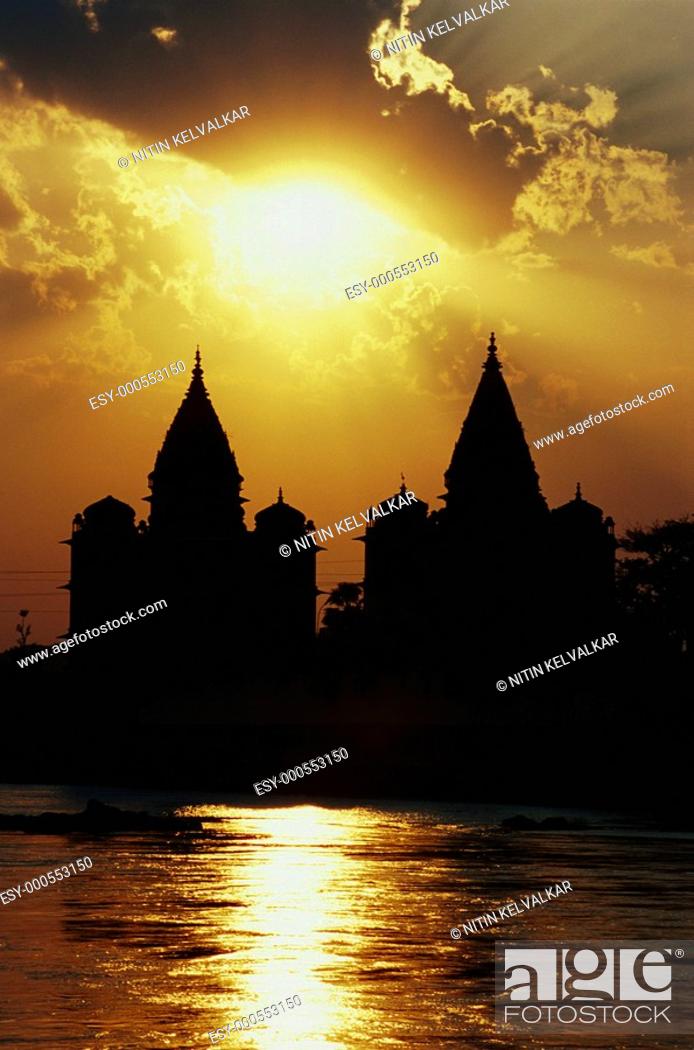 Stock Photo: Cloudy sunset with Chhatri cenotaphs at banks of river Betwa Orchha , Madhya Pradesh , India.