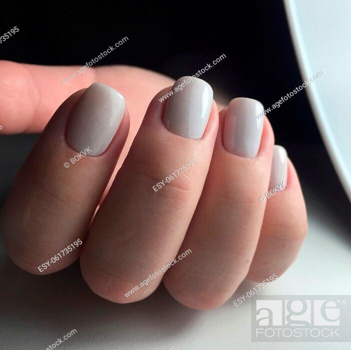 Woman's hands with white nails on the dark background. Nail varnishing in  white color, Stock Photo, Picture And Low Budget Royalty Free Image. Pic.  ESY-061735195 | agefotostock