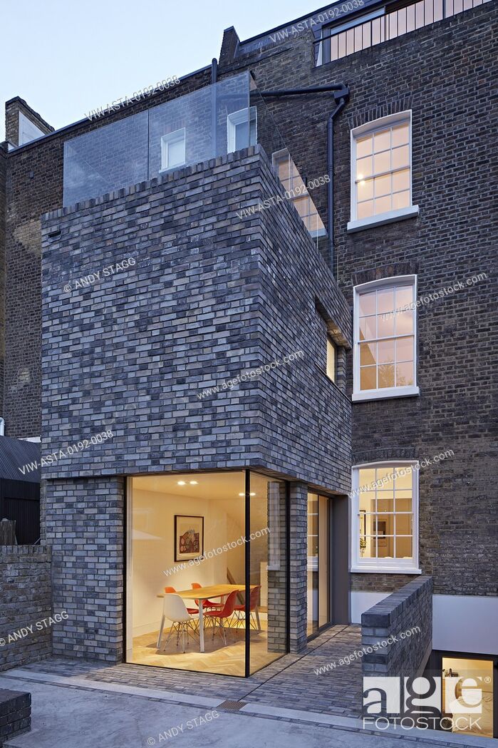 Stock Photo: Overall dusk view of double-height rear extension with corner window on ground level. Queens House, London, United Kingdom.