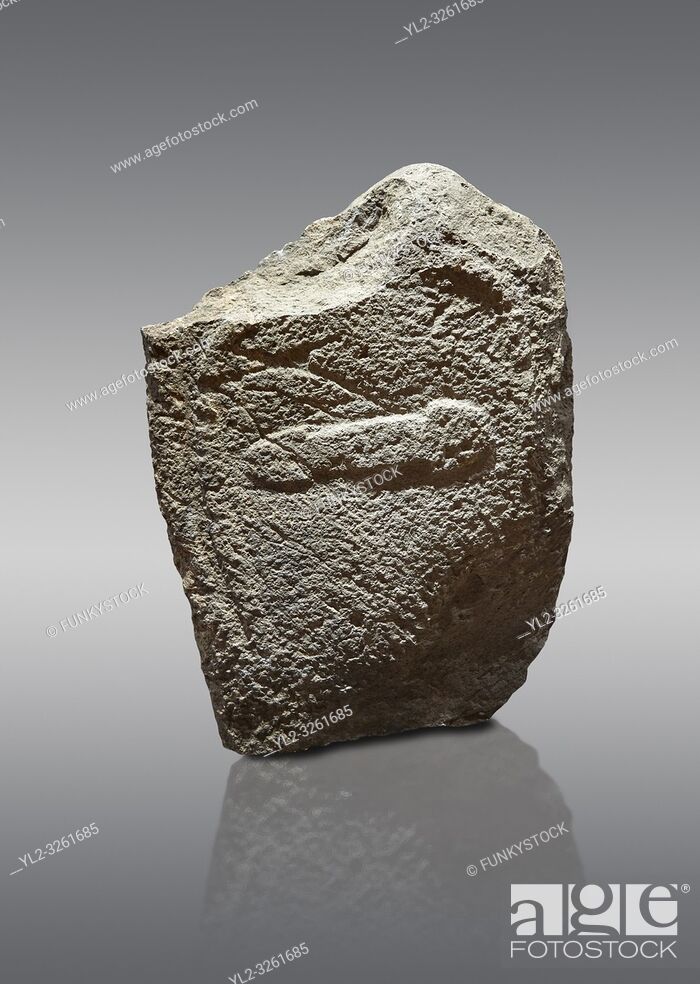 Stock Photo: Late European Neolithic prehistoric Menhir standing stone with carvings on its face side. The representation of a stylalised male figure with the remains of a.