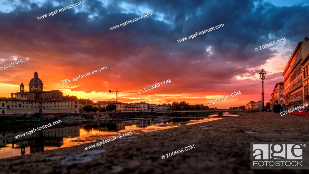 Stock Photo: FLORENCE, TUSCANY/ITALY - OCTOBER 19 : View of buildings along the River Arno at dusk in Florence on October 19, 2019. Unidentified people.
