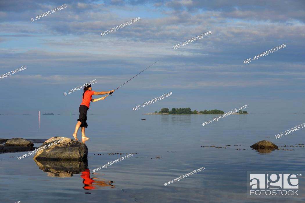 Stock Photo: Woman fishing in sea.
