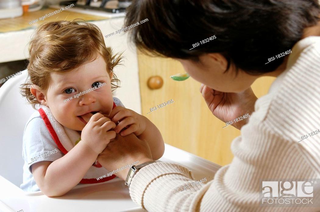 Stock Photo: INFANT EATING<BR>10-month-old baby boy.