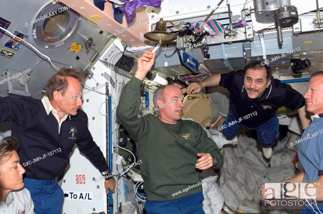Stock Photo: Expedition 13 and STS-115 crew members reunite onboard the International Space Station soon after its docking with the Space Shuttle Atlantis.