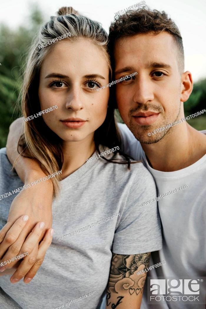 Stock Photo: Portrait of young couple, arm around.