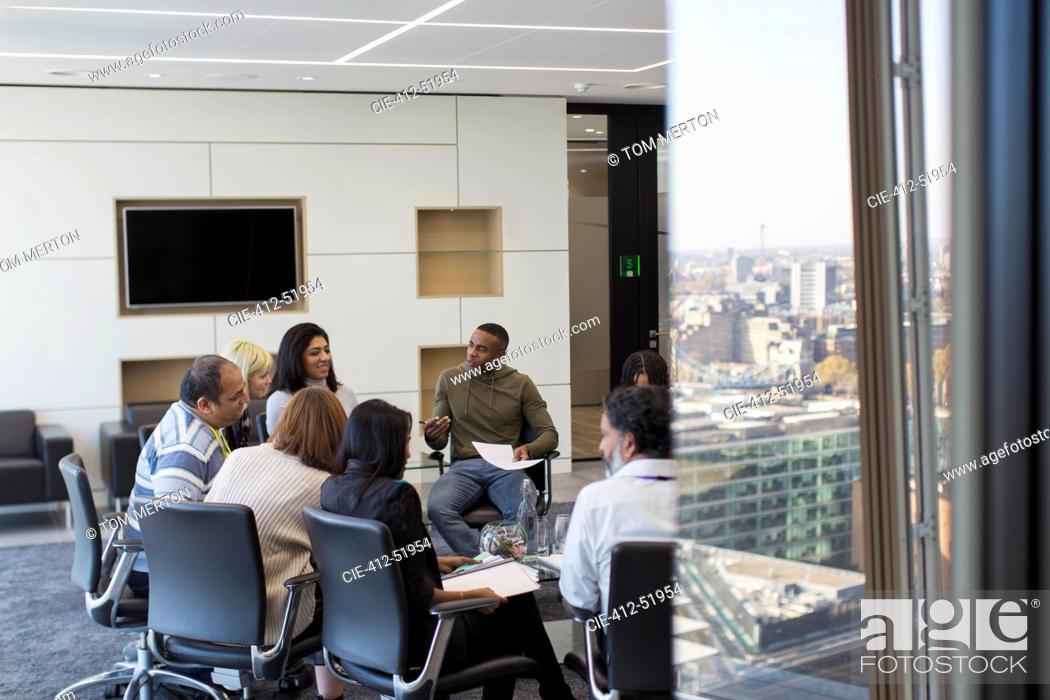 Stock Photo: Business people talking in circle in conference room meeting.