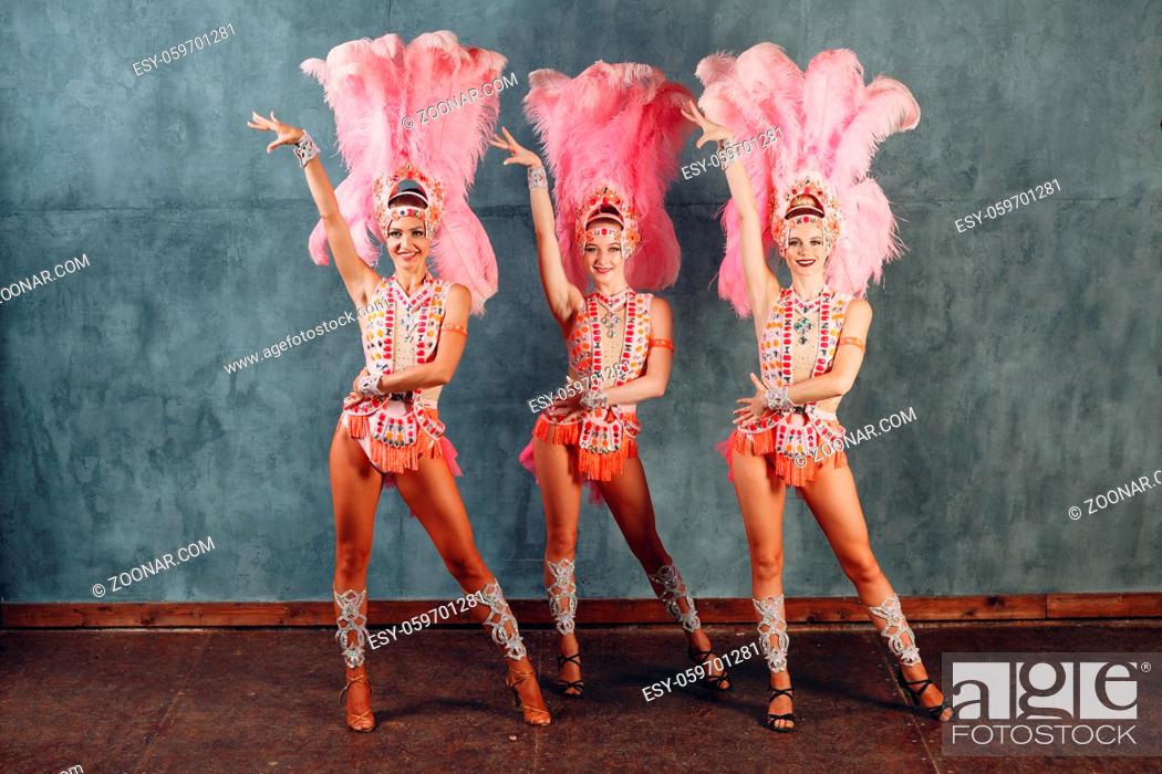 Stock Photo: Three Women in samba or lambada costume with pink feathers plumage.