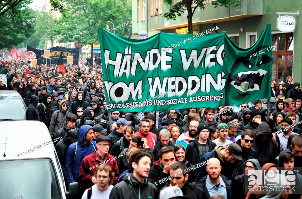 Stock Photo: People take part in the May Day demonstration with a banner reading ""hands off Wedding"" in Berlin-Kreuzberg, Germany, 01 May 2014.
