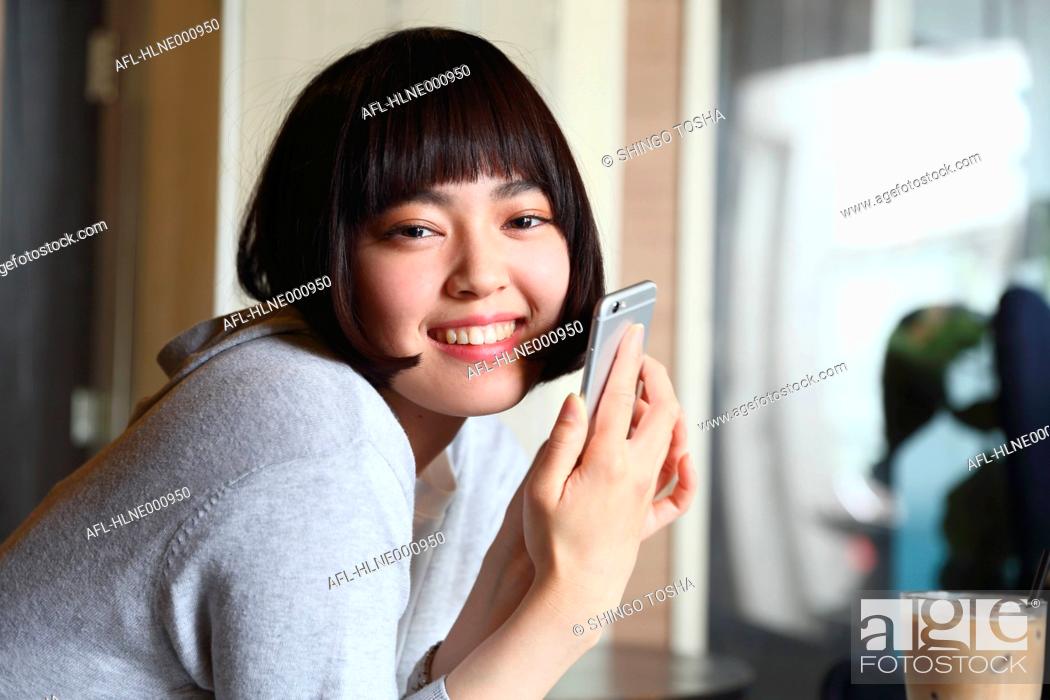 Stock Photo: Young Japanese woman at a cafe downtown Tokyo.