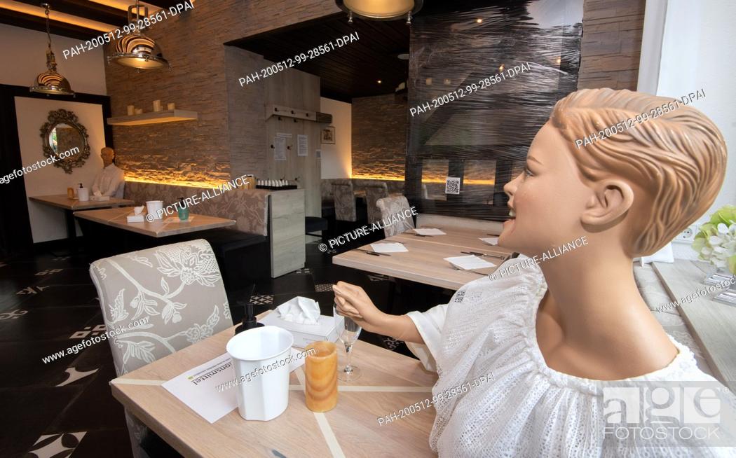 Stock Photo: dpatop - 12 May 2020, Lower Saxony, Laatzen: Dolls sit in the restaurant of the Hotel Haase in the region of Hannover. Because of the Corona requirements.