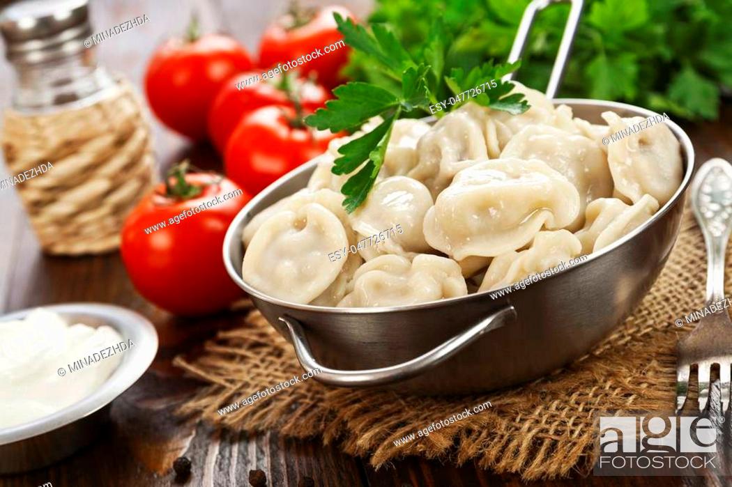 Stock Photo: Delicious dumplings in the pot on the table.