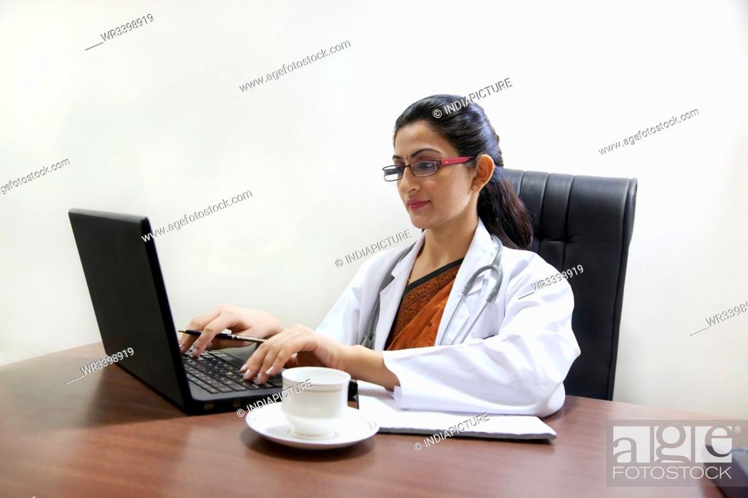 Stock Photo: Doctor working on a laptop.