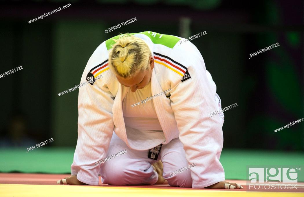 Stock Photo: Germanys Jasmin Kuelbs (white) knees on the matt in the Women's +78kg Final with Andeol of France at the Baku 2015 European Games in Heydar Aliyev Arena in Baku.