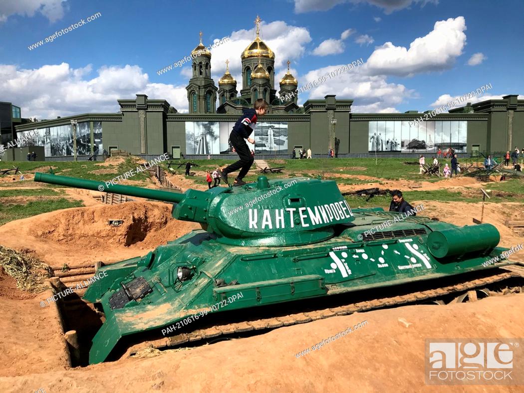 Stock Photo: 07 May 2021, Russia, Moskau: Children play on a Russian T34 tank in a position. The scene is part of the ""Patriot Park"" built from scratch by the Ministry of.