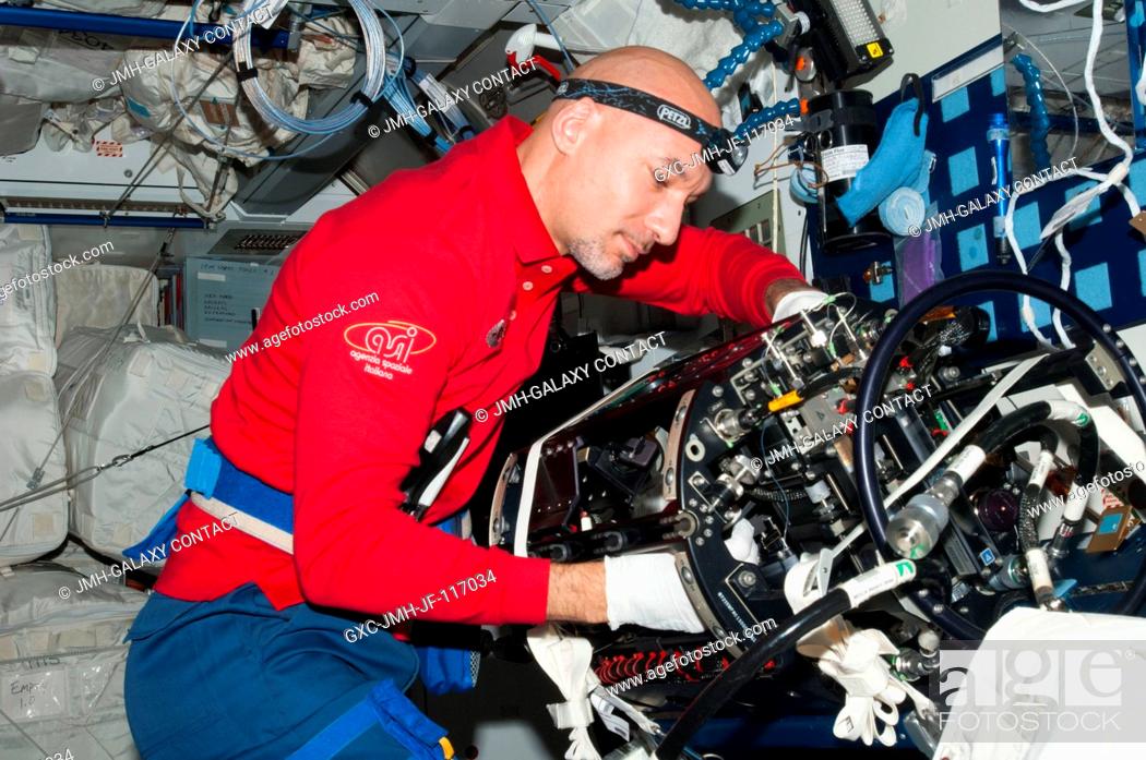 Stock Photo: European Space Agency astronaut Luca Parmitano, Expedition 36 flight engineer, works on the Multi-User Droplet Combustion Apparatus (MDCA) Chamber Insert.