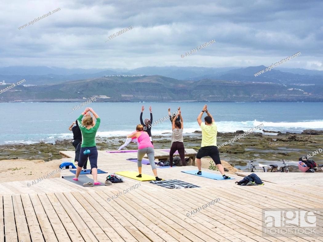 Stock Photo: Yoga class overlooking Atlantic Ocean at El Confital near Las Canteras in Las Palmas, Gran Canaria, Canary Islands, Spain.