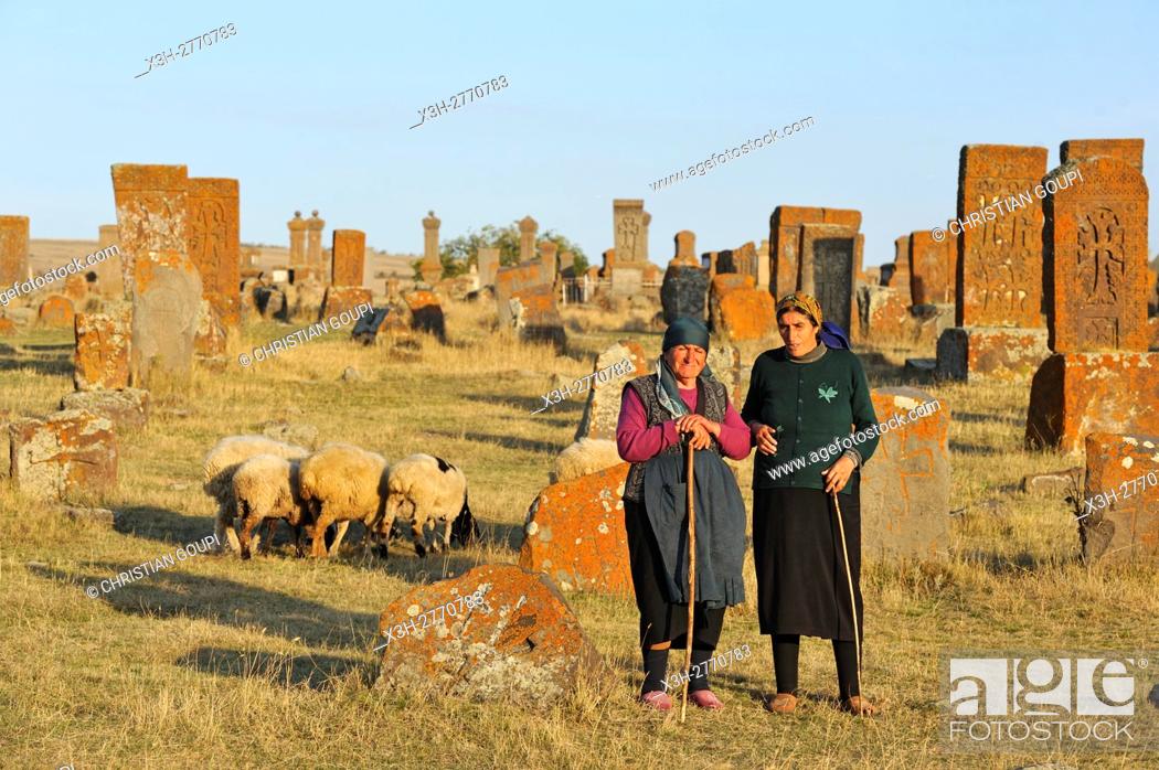 Stock Photo: shepherdess at Noratus cemetery (the largest surviving cemetery with khachkars in Armenia), near Lake Sevan, Gegharkunik region, Armenia, Eurasia.