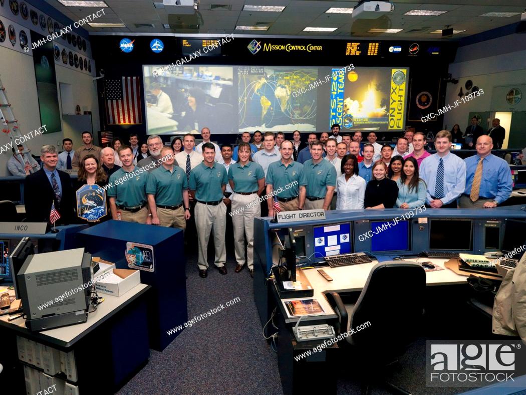 Stock Photo: The members of the STS-126 ascent flight control team and the flight's crewmembers pose for a group portrait in the space shuttle flight control room in the.