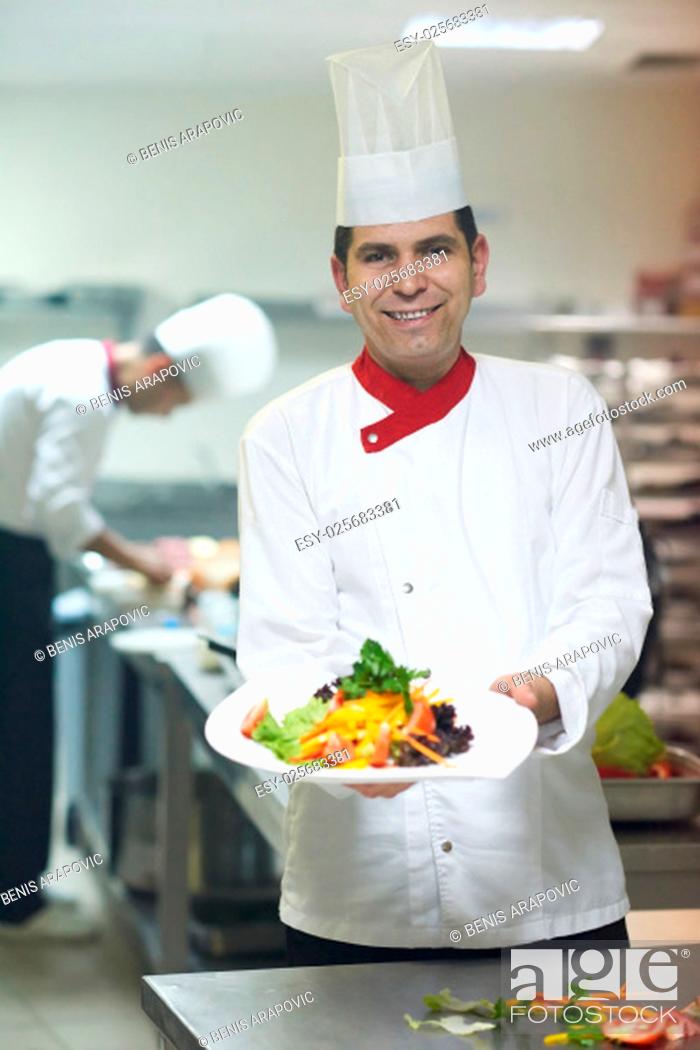 Stock Photo: chef in hotel kitchen preparing and decorating food, delicious vegetables and meat meal dinner.