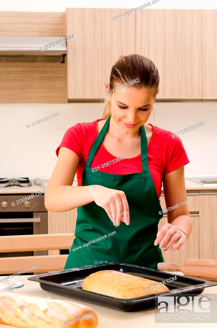 Stock Photo: Young female baker working in kitchen.