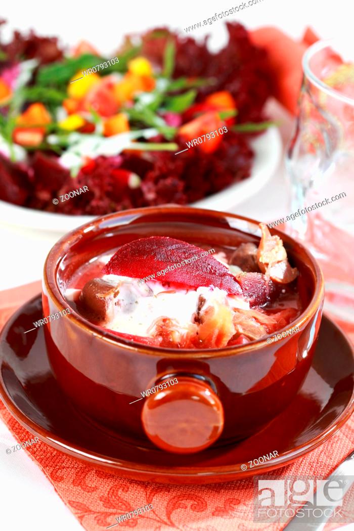Stock Photo: Red cabbage soup with beetroot borscht - Russian national dish with vegetable salad in background.
