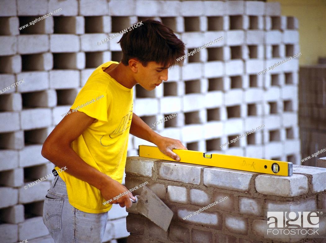 Stock Photo: Apprentice bricklayer at work, - 01/01/2010.