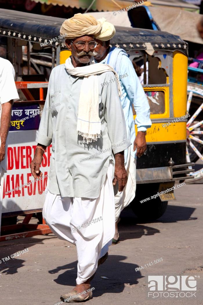 Stock Photo: Indian man in traditional dhoti trousers and turban at Sardar Market at Girdikot, Jodhpur, Rajasthan, Northern India.
