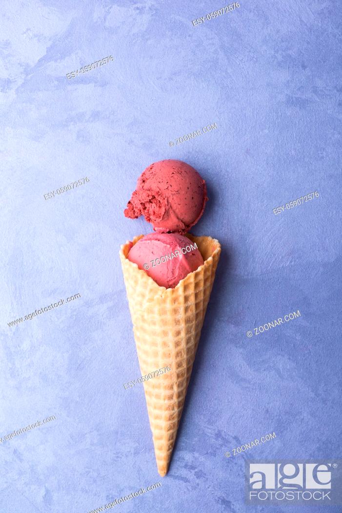 Stock Photo: ice cream in a waffle horn on an ornamental purple background, top view.