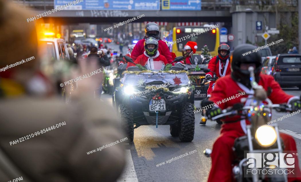 Stock Photo: 10 December 2022, Berlin: Participants in the ""Santa Claus on Road"" campaign ride through the city on their Christmas-decorated machines.