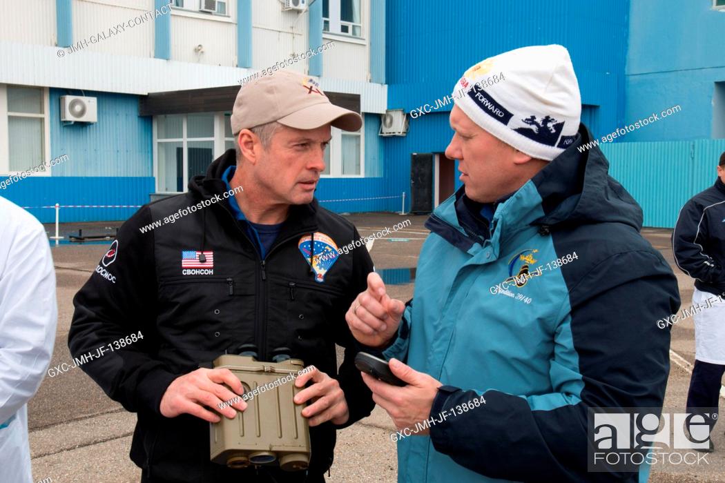 Stock Photo: Outside the Integration Facility at the Baikonur Cosmodrome in Kazakhstan, Expedition 3940 Flight Engineer Steve Swanson of NASA (left) and Flight Engineer Oleg.