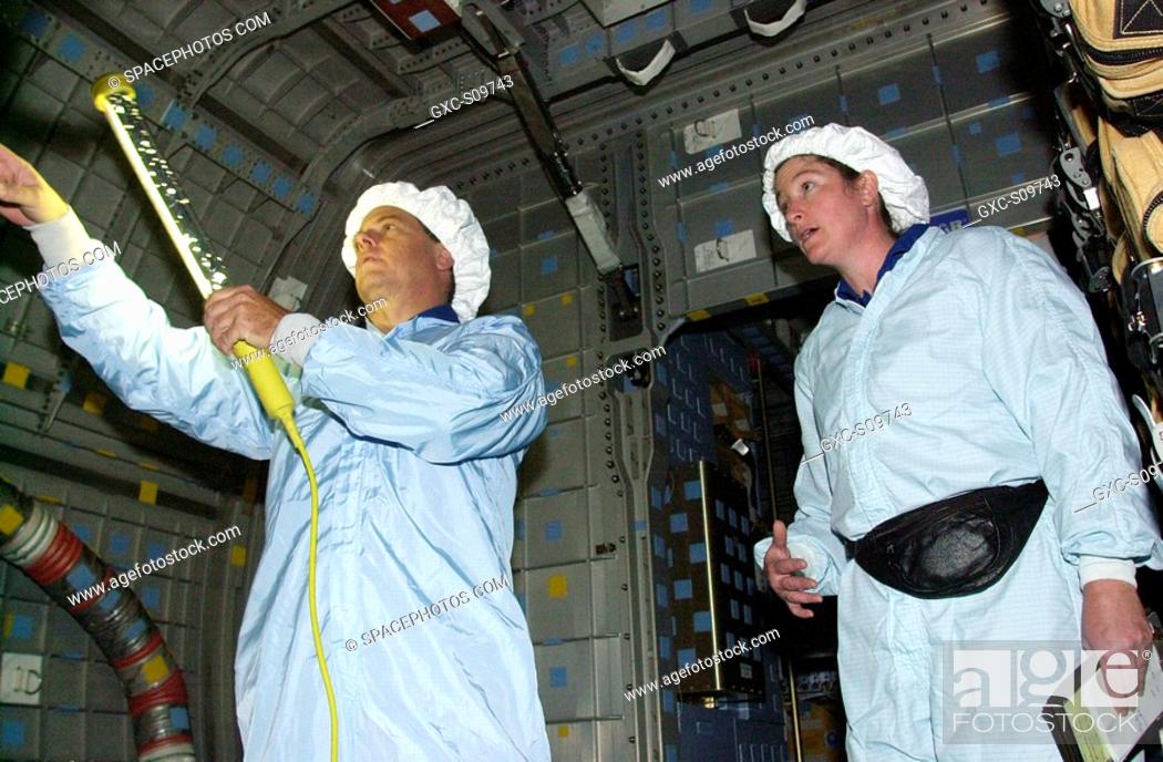 Stock Photo: 06/08/2002 - STS-107 Mission Specialists Ilan Ramon, with the Israeli Space Agency, and Laurel Clark check out equipment in the SHI Research Double Module.