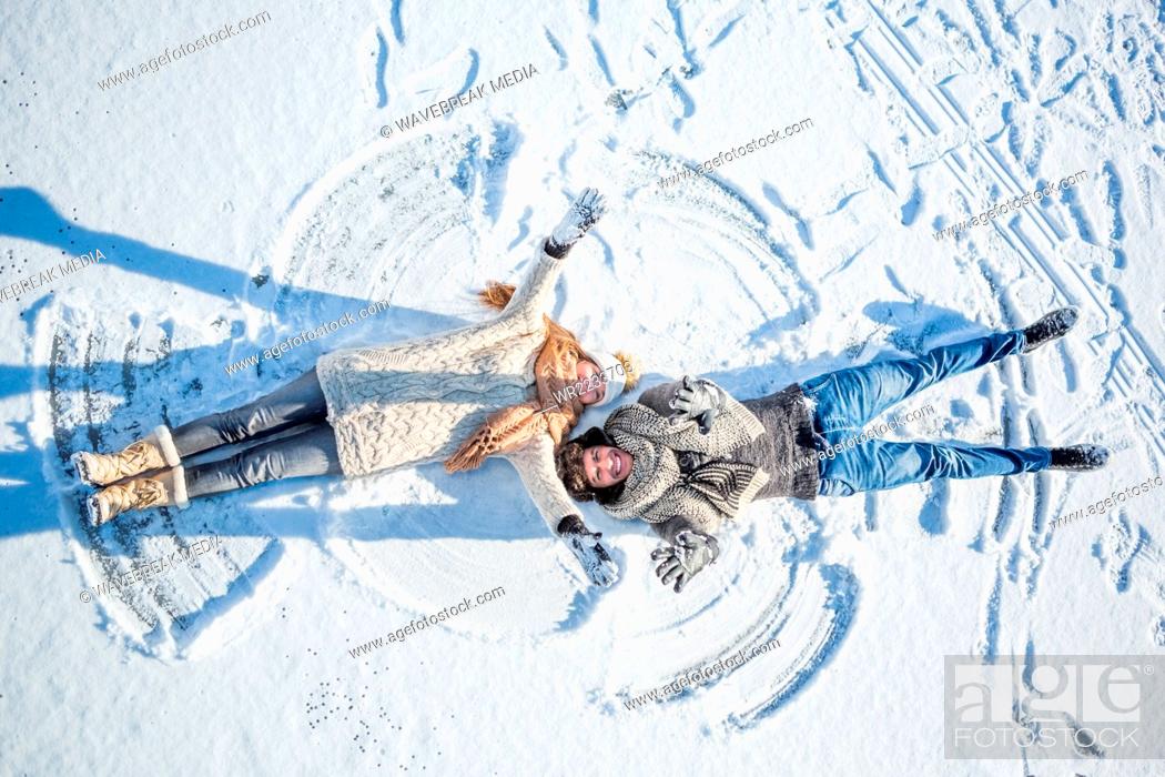 Stock Photo: Couple doing snow angel.