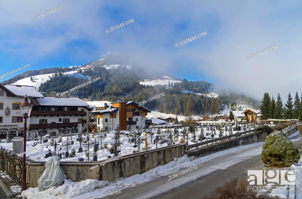 Stock Photo: Cemetery in Kirchberg in Tyrol, Austria. Sunny winter morning, low clouds.