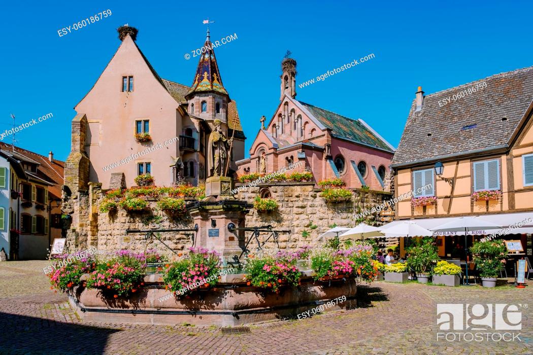 Stock Photo: Eguisheim, Alsace, France July 2021, Traditional colorful halt-timbered houses in Eguisheim Old Town on Alsace Wine Route, France.