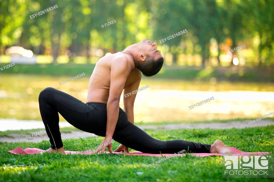 Stock Photo: Profile of sporty young Indian man practicing yoga, fitness, pilates on riverbank in park, doing low lunge exercise, Ashva Sanchalasana on lake in park.