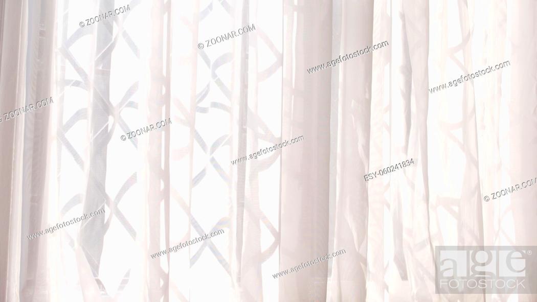 Stock Photo: White voile or net curtain hung at criss cross design window. High quality photo with copy space.