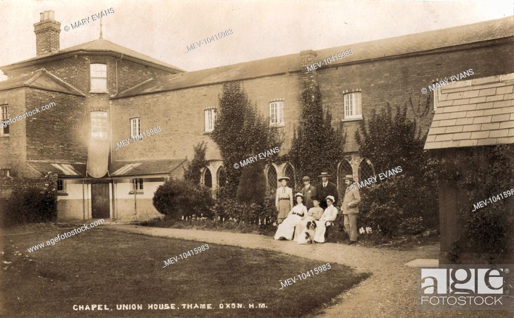 Stock Photo: A view of the Thame Union workhouse from one of its internal yards with the workhouse chapel in the background. Posed for the photographer are what appear to be.