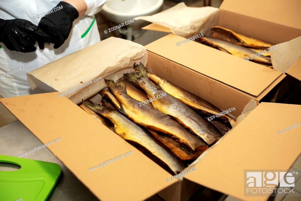 Stock Photo: Smoked mackerel in a paper box. Fishing industry.
