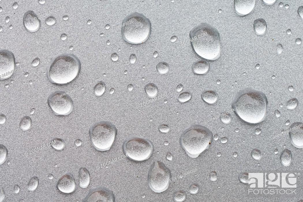 Stock Photo: Water drops on a shiny metal surface.