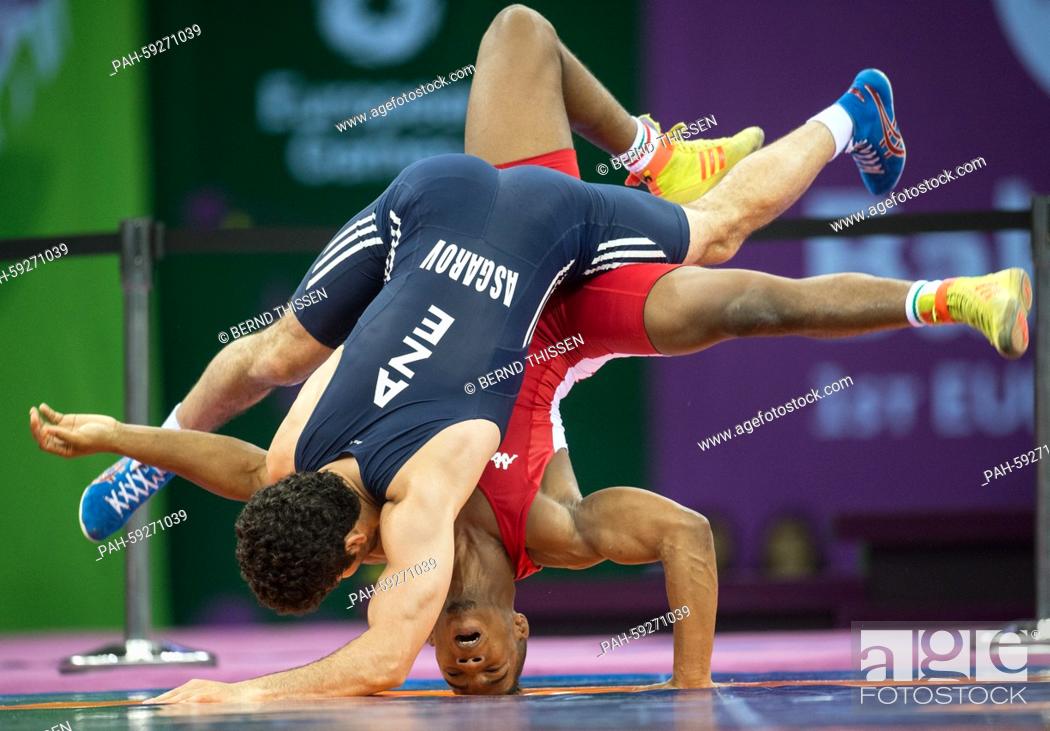 Stock Photo: Chamizo Marquez from Italy (red) competes with Togrul Asgarov (blue) of Azerbaijan in the wrestling Men's 65kg Freestyle Final at the Baku 2015 European Games.