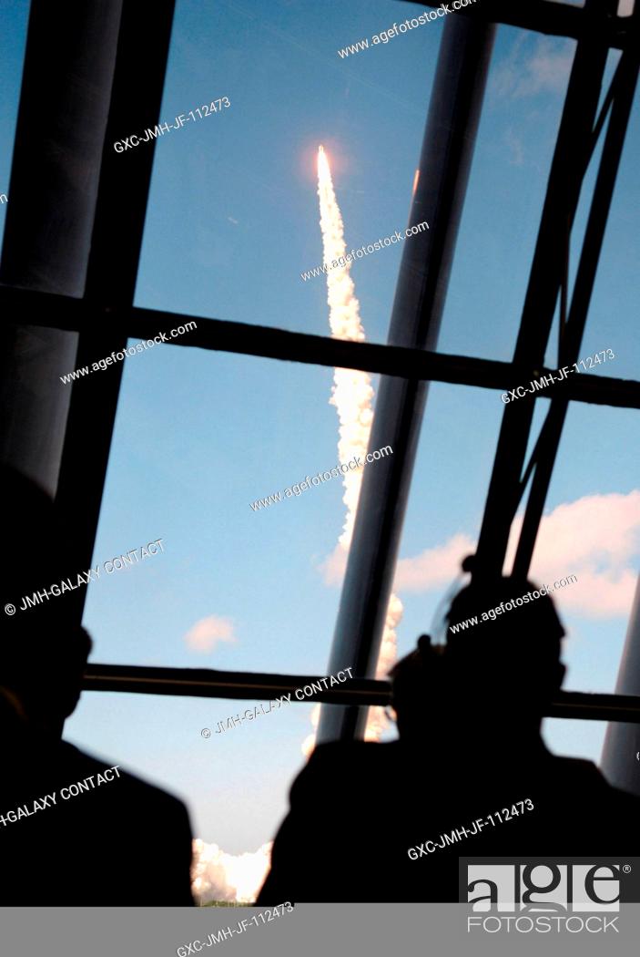 Stock Photo: View of personnel watching the launch of Space Shuttle Discovery through the windows of the Launch Control Center at the Kennedy Space Center.