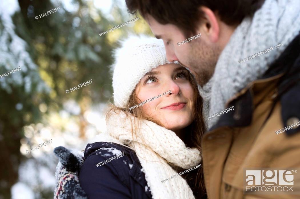 Stock Photo: Portrait of hHappy young woman face to face with her partner in winter.