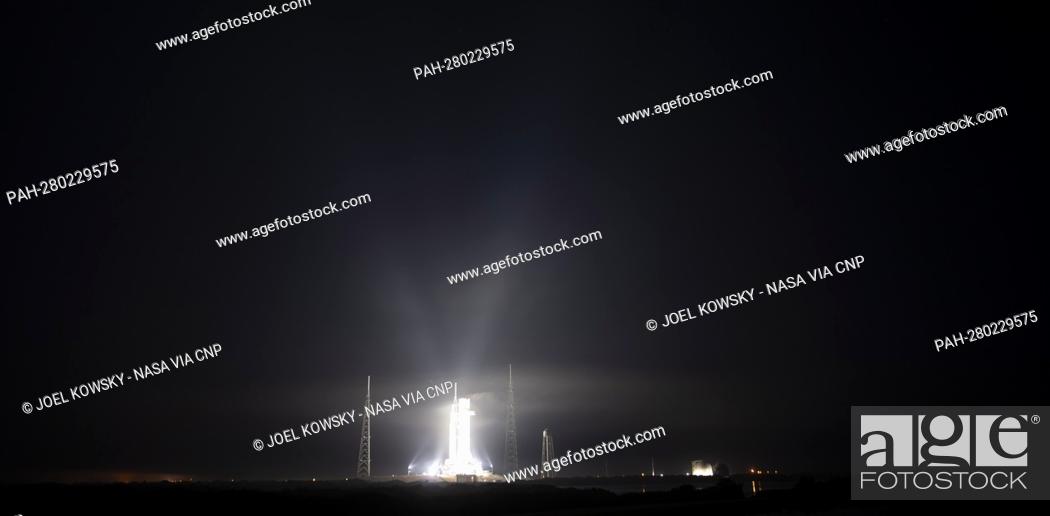 Stock Photo: NASA’s Space Launch System (SLS) rocket with the Orion spacecraft aboard is seen illuminated by spotlights atop a mobile launcher at Launch Complex 39B, Friday.
