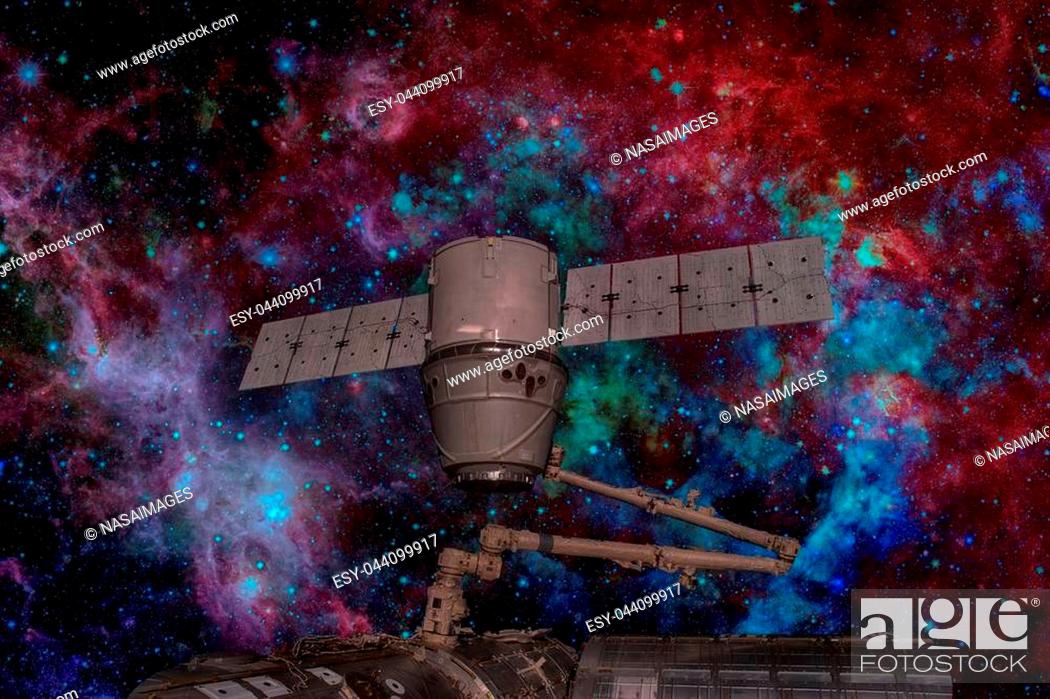 Stock Photo: SpaceX Dragon orbiting the planet Earth. Elements of this image furnished by NASA.