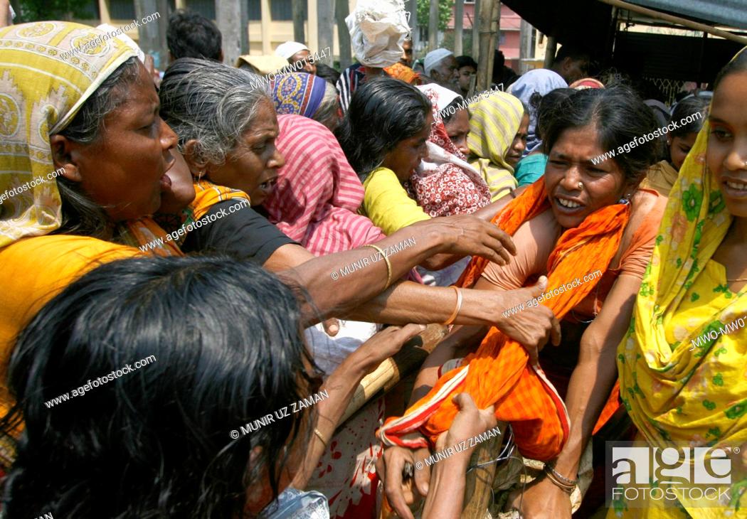 Stock Photo: People from low income group crowd at a fair price shop, run by Bangladesh Rifles or BDR, to collect rice Global rice stock has reached the lowest in the last.